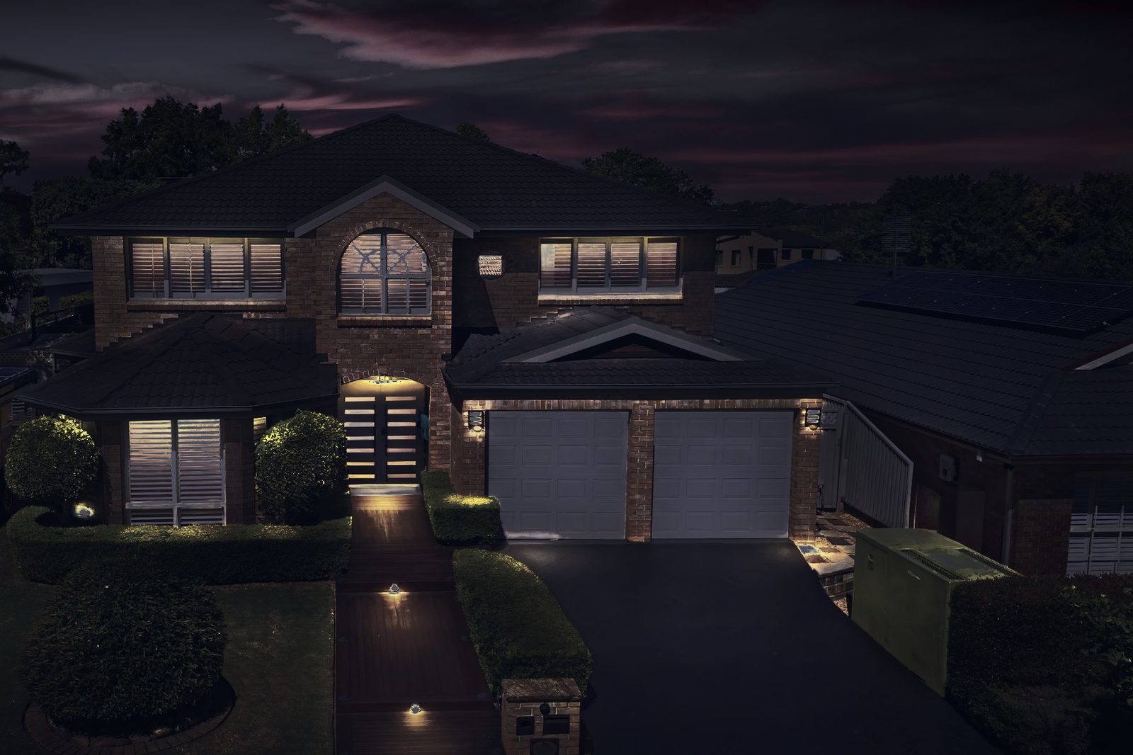 two-story brick home before lighting