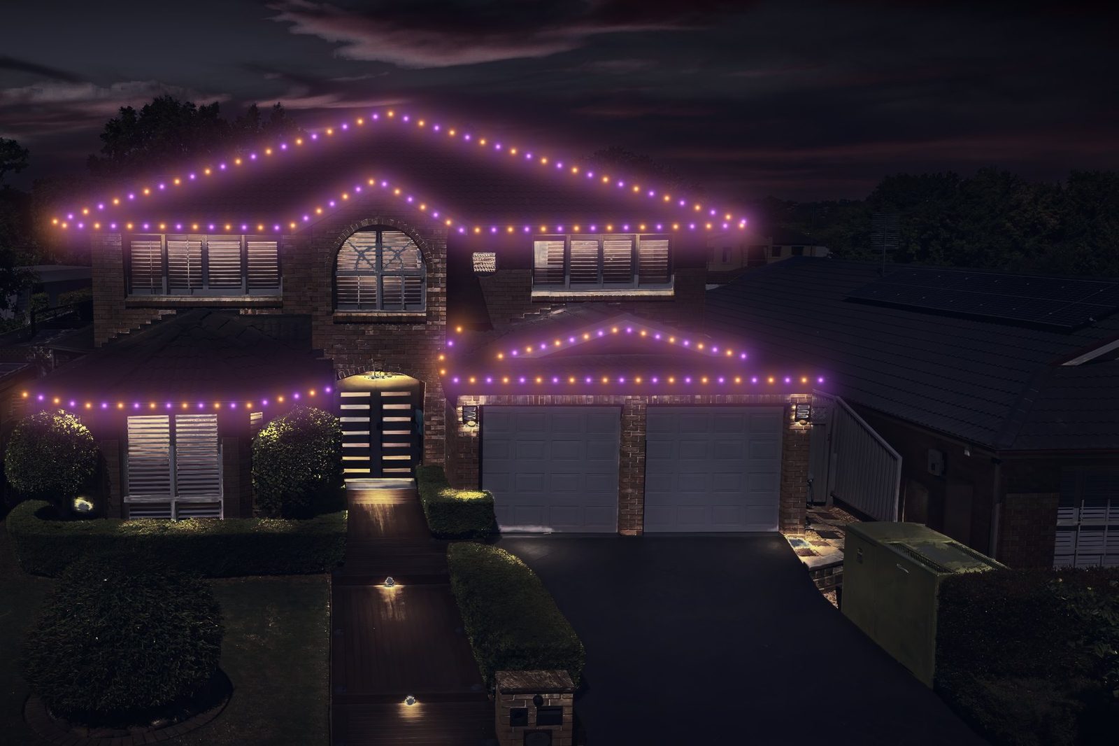 two-story brick home after lighting
