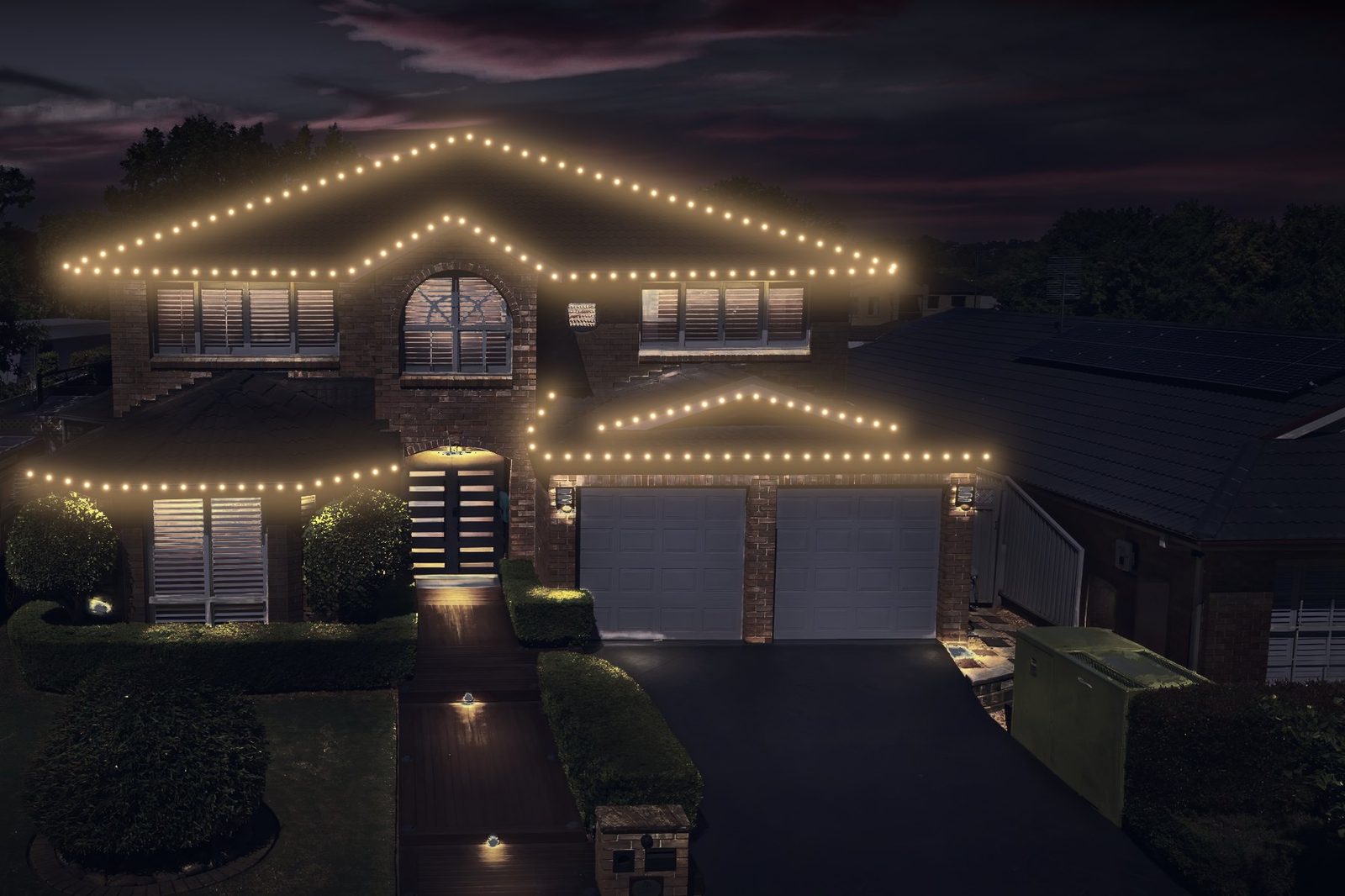 two-story brick home after lighting