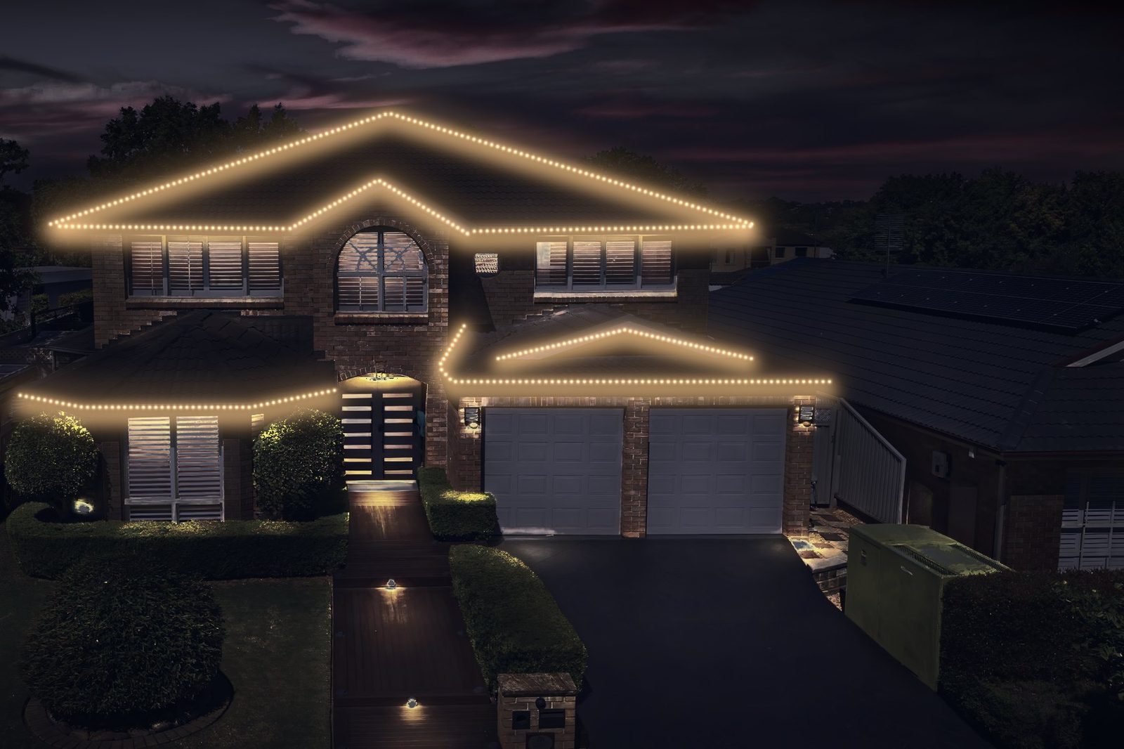 two-story brick home after lighting
