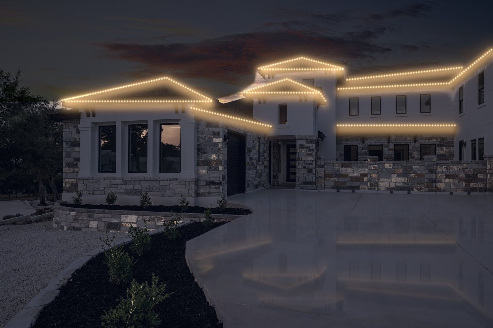 stone and stucco home after lighting