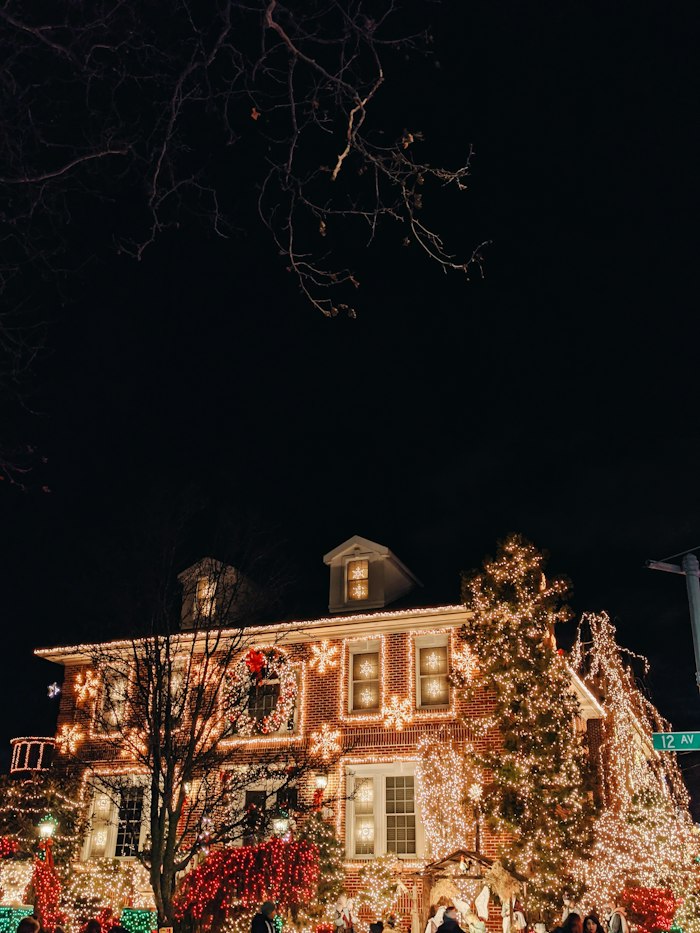 Well-lit house at night with holiday lighting