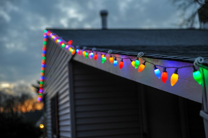 Close-up of string lights along a roof edge