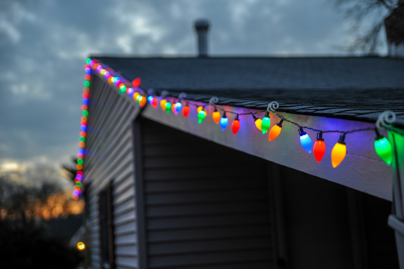 Close-up of string lights along a roof edge